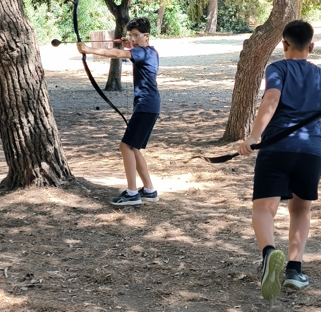 Players engage in an exciting Archery Tag game, aiming arrows.
