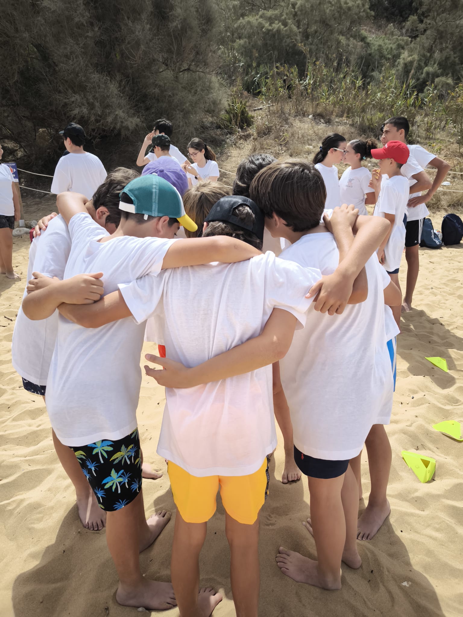 A group of friends standing in a circle, ready to begin a fun outdoor game together.