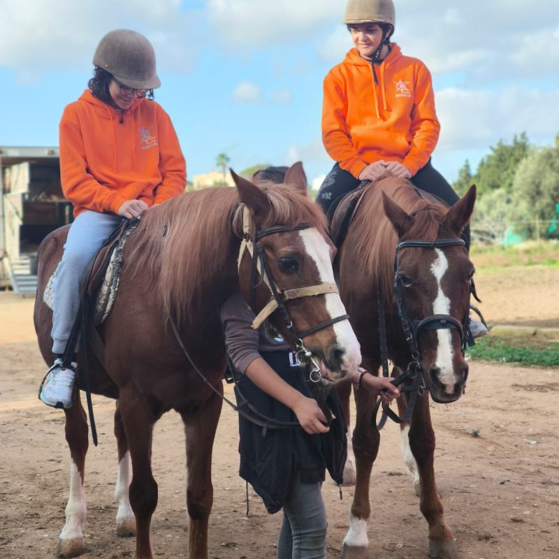 two girls on horses ready to start the journy